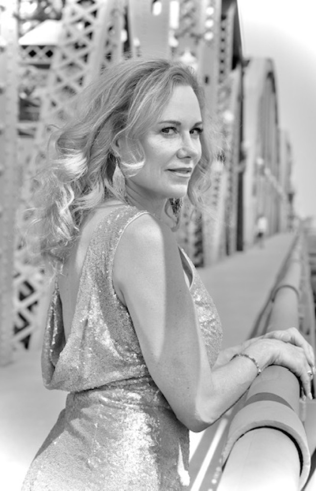 Deone Jennings in a sequined dress, looking back over her shoulder on a bridge